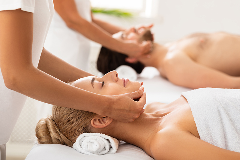 Relaxed Couple Enjoying Massage Lying Together At Spa Center